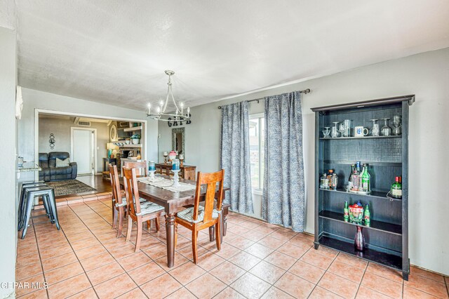 10705 Vista Alegre Dr, El Paso, TX 79935 - dining area featuring a chandelier and light tile patterned floors