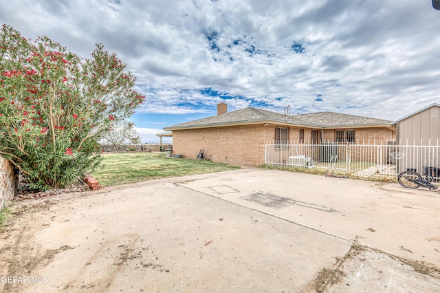 10705 Vista Alegre Dr, El Paso, TX 79935 - back of property with brick siding, a chimney, and a patio
