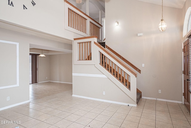 3340 Tierra Yvette Ln, El Paso, TX 79938 - foyer with a towering ceiling, stairway, tile patterned floors, and a chandelier