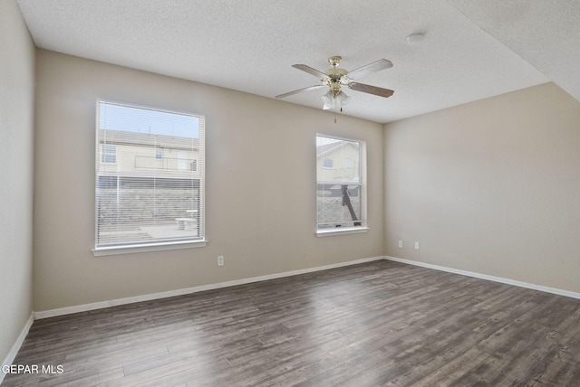 3340 Tierra Yvette Ln, El Paso, TX 79938 - empty room featuring healthy amount of natural light, dark wood-type flooring, ceiling fan, a textured ceiling, and a smoke detector