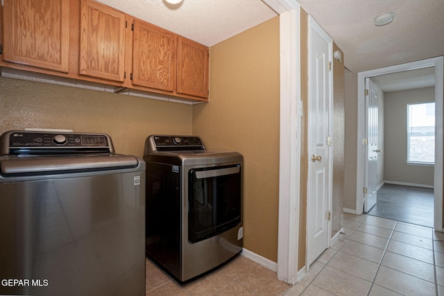 3340 Tierra Yvette Ln, El Paso, TX 79938 - laundry room with cabinet space, washing machine and clothes dryer, and light tile patterned floors