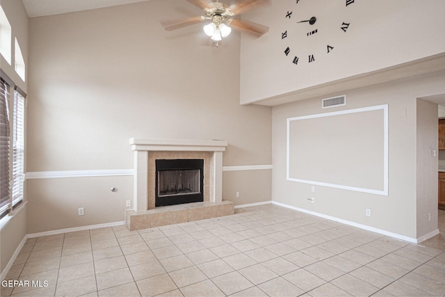 3340 Tierra Yvette Ln, El Paso, TX 79938 - unfurnished living room with high vaulted ceiling, a ceiling fan, a tile fireplace, and light tile patterned flooring