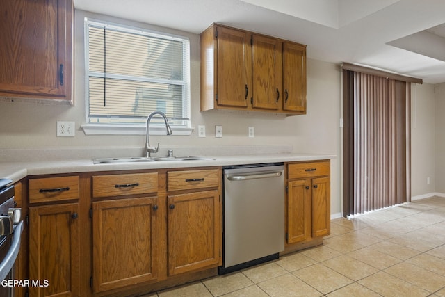 3340 Tierra Yvette Ln, El Paso, TX 79938 - kitchen featuring stainless steel dishwasher, light countertops, brown cabinets, and light tile patterned floors