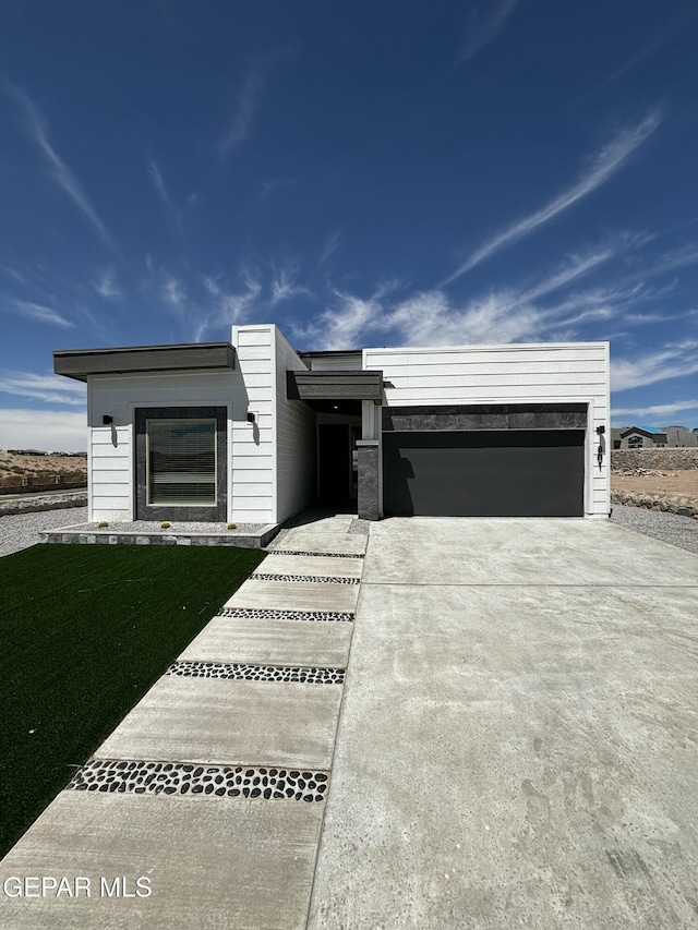 13066 Emerald Isle St, El Paso, TX 79928 - view of front of home featuring a garage and driveway