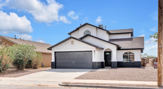 6913 Jericho Tree Dr, El Paso, TX 79934 - view of front of home featuring stone siding, an attached garage, concrete driveway, and stucco siding