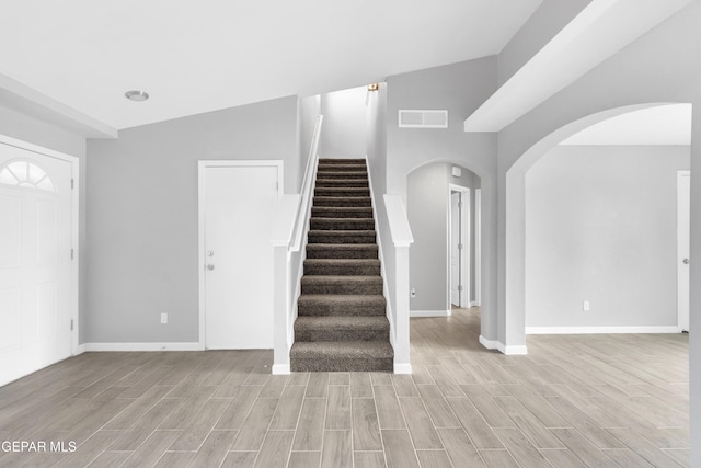 6913 Jericho Tree Dr, El Paso, TX 79934 - stairway with wood finished floors and arched walkways