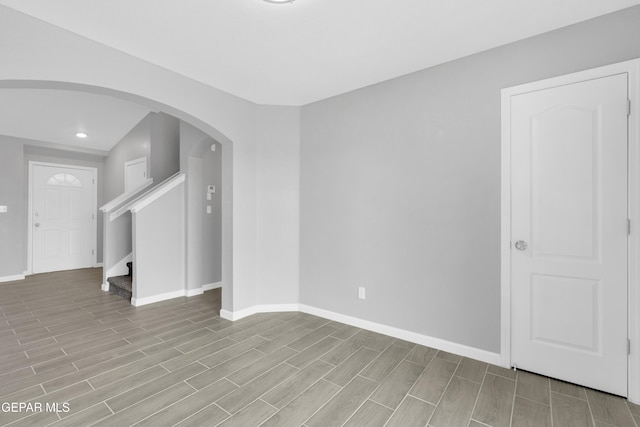 6913 Jericho Tree Dr, El Paso, TX 79934 - spare room with arched walkways, recessed lighting, light wood finished floors, and stairs
