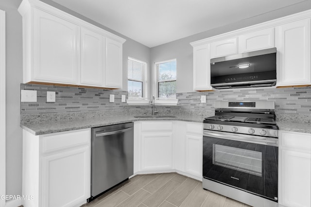 6913 Jericho Tree Dr, El Paso, TX 79934 - kitchen with appliances with stainless steel finishes, white cabinetry, decorative backsplash, and light stone countertops