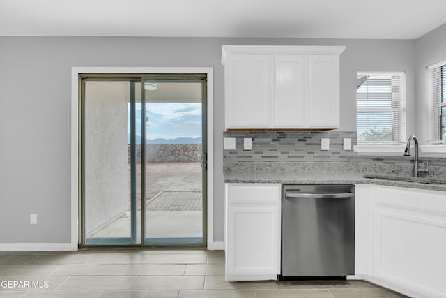 6913 Jericho Tree Dr, El Paso, TX 79934 - kitchen featuring stainless steel dishwasher, light stone counters, white cabinetry, and decorative backsplash