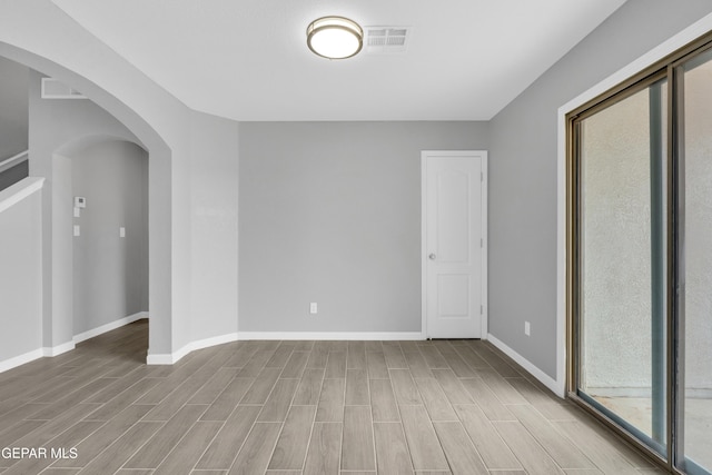 6913 Jericho Tree Dr, El Paso, TX 79934 - empty room featuring wood finished floors and arched walkways