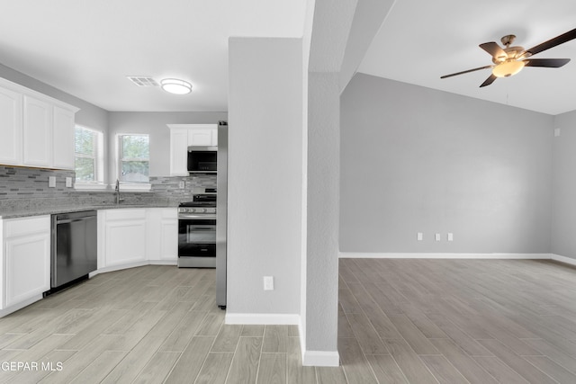 6913 Jericho Tree Dr, El Paso, TX 79934 - kitchen featuring stainless steel appliances, light wood-type flooring, ceiling fan, decorative backsplash, and light stone countertops