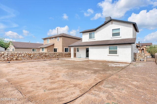6913 Jericho Tree Dr, El Paso, TX 79934 - back of house with stucco siding, roof mounted solar panels, a patio area, and a chimney