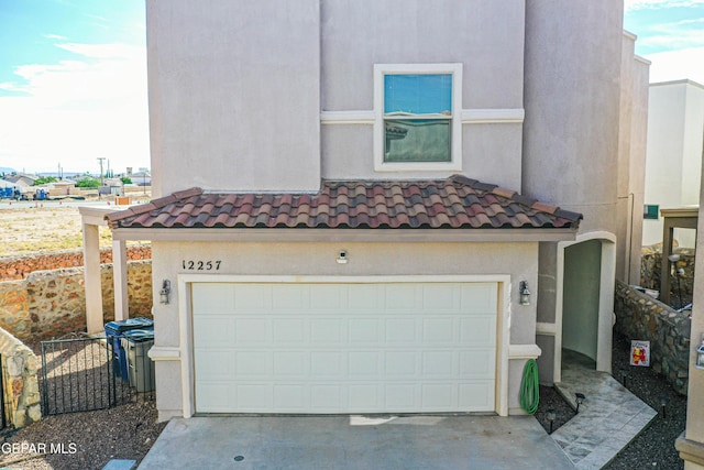 12257 Gaudi Way, El Paso, TX 79938 - view of front facade featuring an attached garage, stucco siding, concrete driveway, and a tiled roof