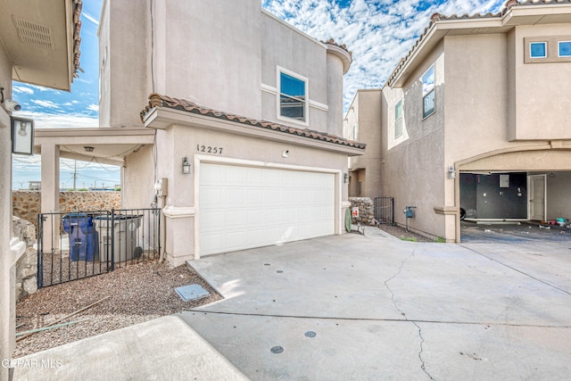 12257 Gaudi Way, El Paso, TX 79938 - view of front of home with stucco siding, concrete driveway, a garage, and a tiled roof