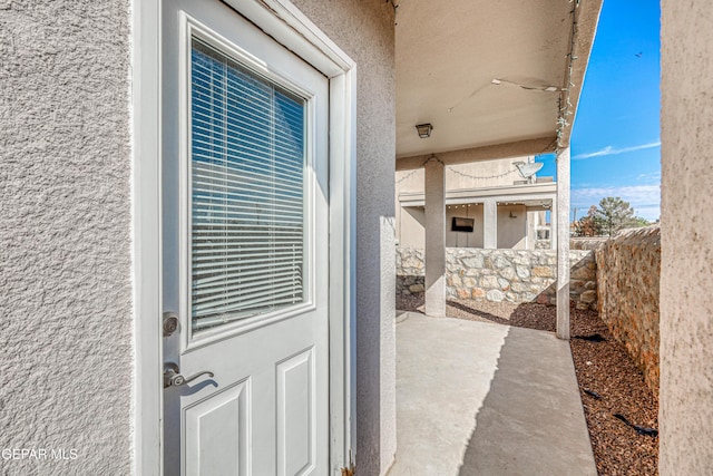 12257 Gaudi Way, El Paso, TX 79938 - doorway to property with stucco siding and a patio
