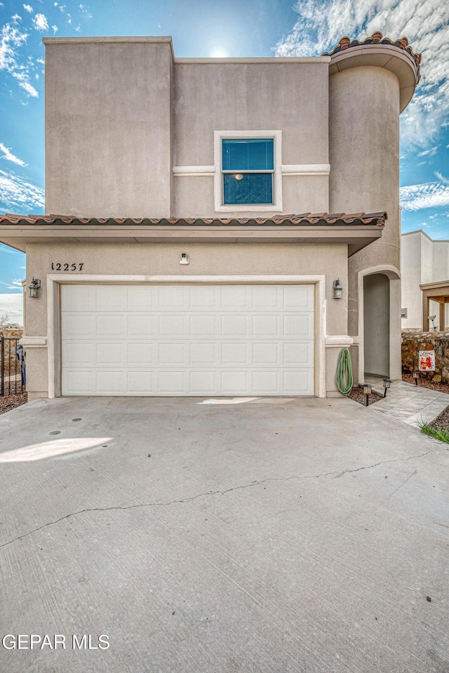 12257 Gaudi Way, El Paso, TX 79938 - view of front of house with an attached garage, stucco siding, and driveway