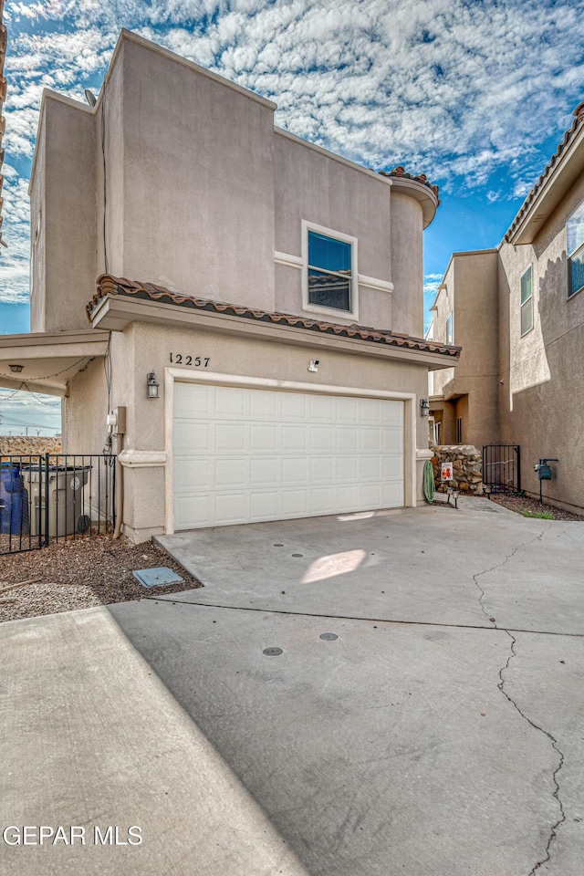 12257 Gaudi Way, El Paso, TX 79938 - view of front of property featuring an attached garage, stucco siding, driveway, and a tile roof