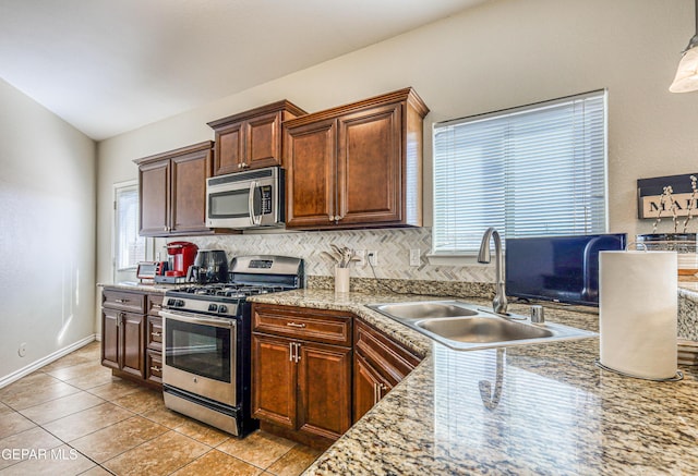 12257 Gaudi Way, El Paso, TX 79938 - kitchen with appliances with stainless steel finishes, tasteful backsplash, and light tile patterned floors