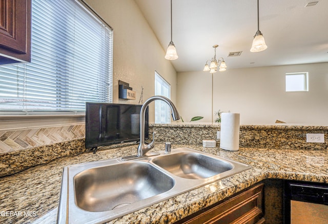 12257 Gaudi Way, El Paso, TX 79938 - kitchen view of a chandelier, dishwasher, pendant lighting, and dark brown cabinetry
