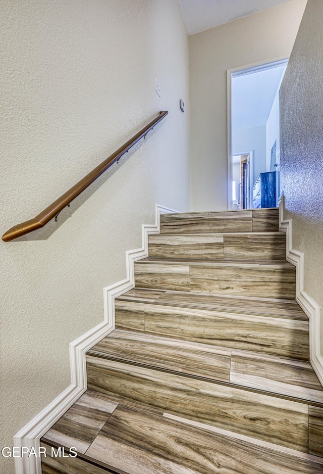 12257 Gaudi Way, El Paso, TX 79938 - staircase with a textured wall