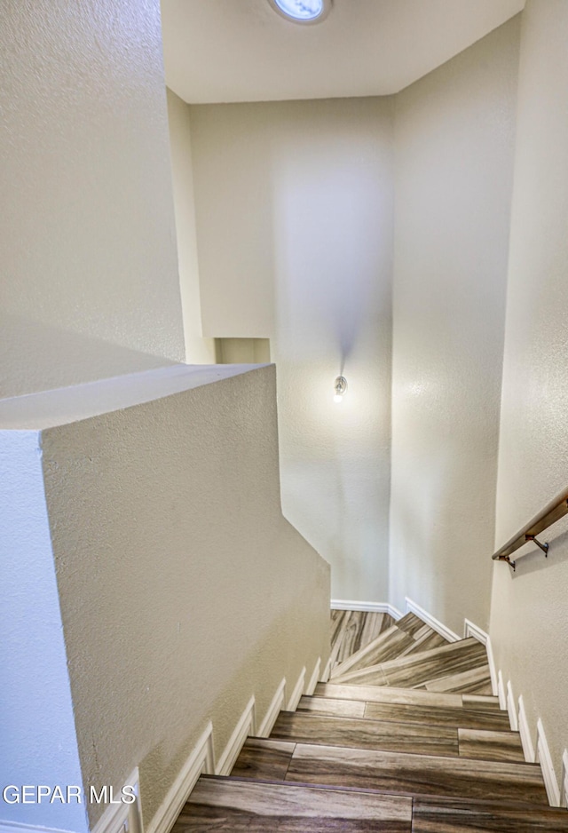 12257 Gaudi Way, El Paso, TX 79938 - stairs with wood finished floors and a textured wall