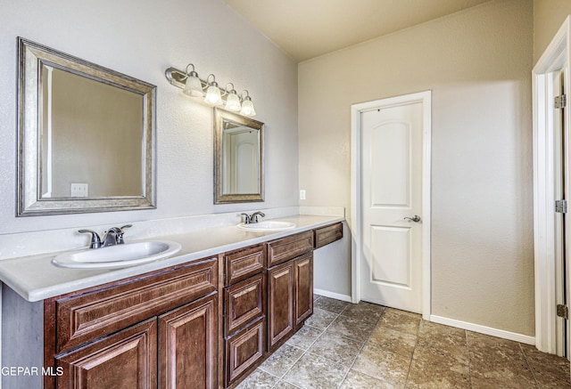 12257 Gaudi Way, El Paso, TX 79938 - bathroom with double vanity and baseboards
