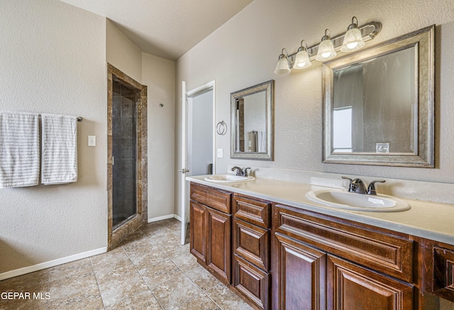 12257 Gaudi Way, El Paso, TX 79938 - full bath featuring a shower stall, double vanity, and a textured wall