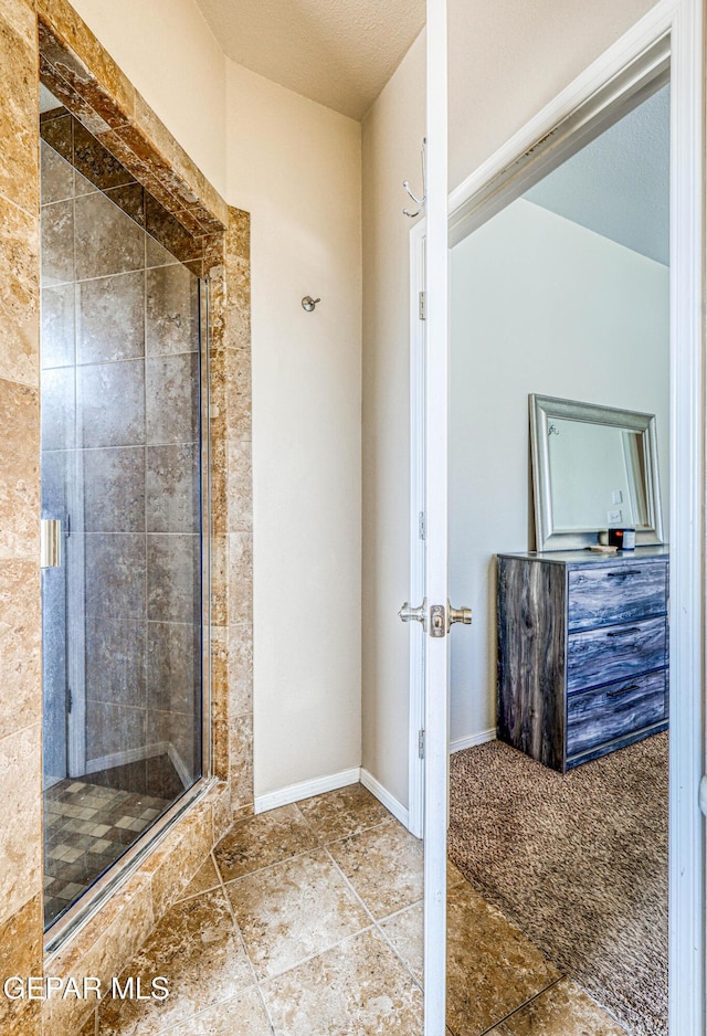 12257 Gaudi Way, El Paso, TX 79938 - bathroom with a shower stall and baseboards