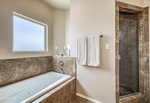 12257 Gaudi Way, El Paso, TX 79938 - bathroom with a stall shower, a whirlpool tub, and a textured wall