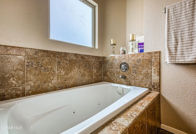 12257 Gaudi Way, El Paso, TX 79938 - full bathroom with a textured wall and a whirlpool tub
