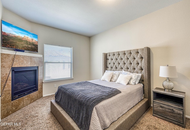 12257 Gaudi Way, El Paso, TX 79938 - bedroom with carpet floors and a tiled fireplace