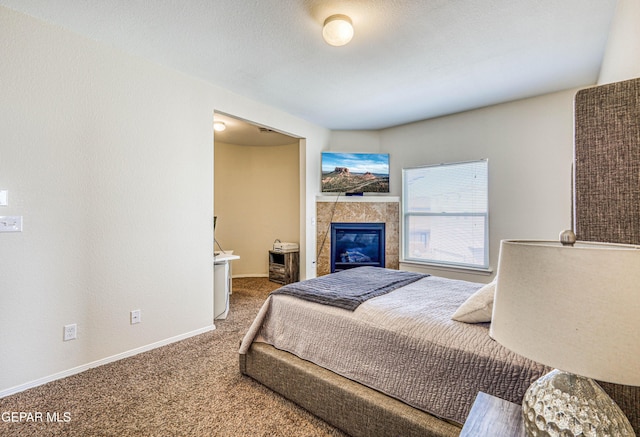 12257 Gaudi Way, El Paso, TX 79938 - bedroom featuring carpet and a tile fireplace