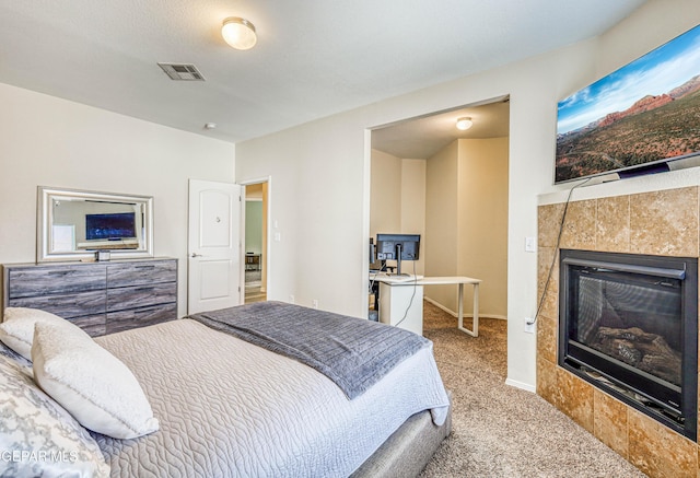 12257 Gaudi Way, El Paso, TX 79938 - bedroom featuring carpet flooring and a tile fireplace