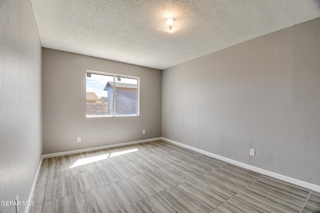 10712 Georgetown St, El Paso, TX 79924 - spare room with a textured ceiling and baseboards