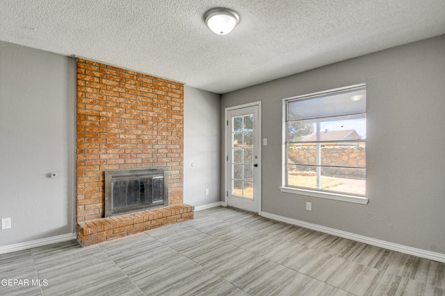 10712 Georgetown St, El Paso, TX 79924 - unfurnished living room featuring a textured ceiling, a fireplace, and tile patterned floors