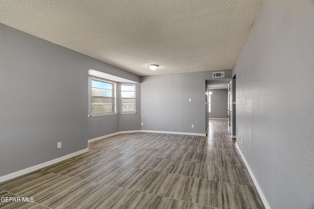 10712 Georgetown St, El Paso, TX 79924 - empty room with a textured ceiling and baseboards
