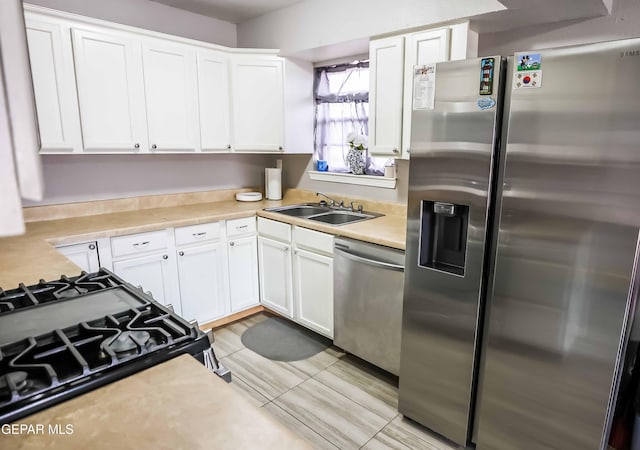 10712 Georgetown St, El Paso, TX 79924 - kitchen with stainless steel appliances, white cabinets, and light countertops