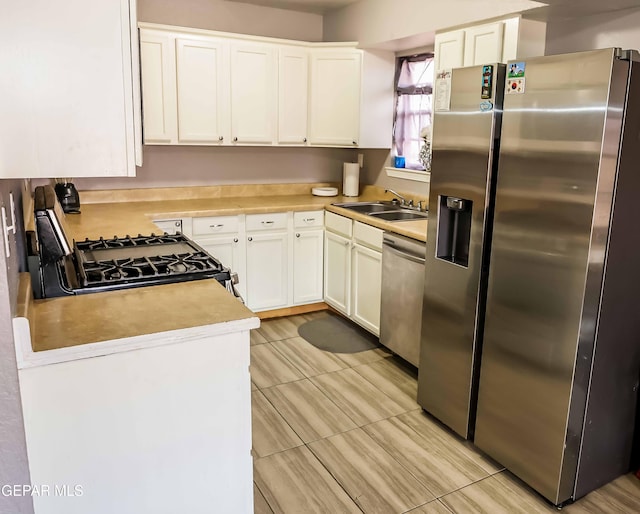 10712 Georgetown St, El Paso, TX 79924 - kitchen featuring appliances with stainless steel finishes, light countertops, white cabinets, and light tile patterned floors