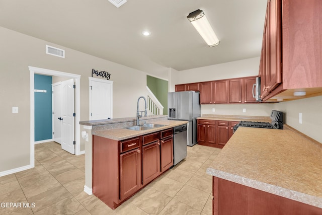 2937 Pino Triste Dr, El Paso, TX 79938 - kitchen featuring appliances with stainless steel finishes, a center island with sink, light countertops, and light tile patterned floors