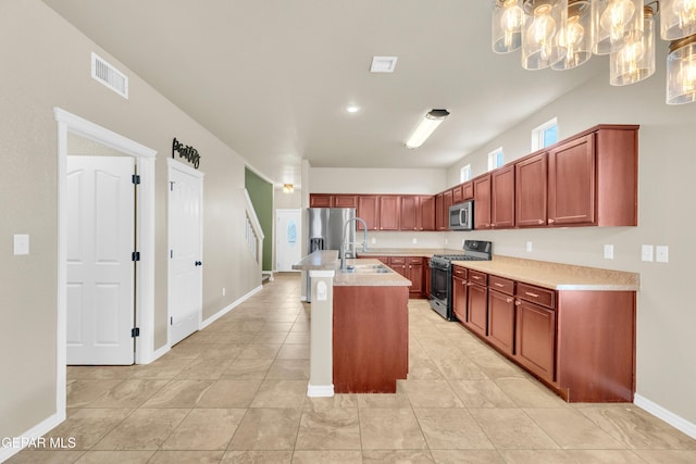 2937 Pino Triste Dr, El Paso, TX 79938 - kitchen with black range with gas stovetop, stainless steel microwave, light countertops, and light tile patterned floors