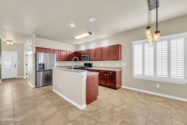 2937 Pino Triste Dr, El Paso, TX 79938 - kitchen featuring appliances with stainless steel finishes, light countertops, light tile patterned floors, and pendant lighting