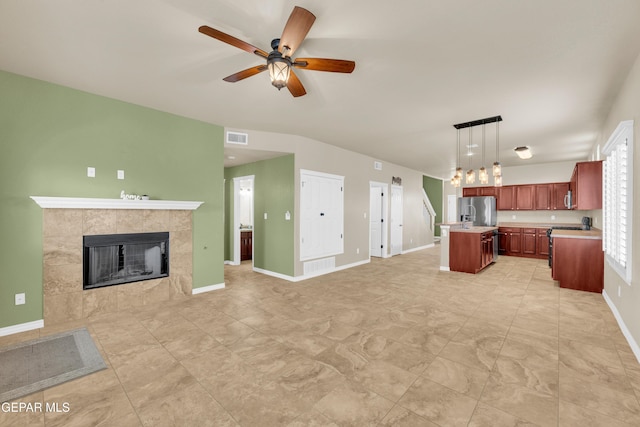 2937 Pino Triste Dr, El Paso, TX 79938 - unfurnished living room with a tiled fireplace and ceiling fan