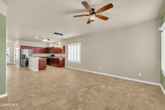 2937 Pino Triste Dr, El Paso, TX 79938 - kitchen with appliances with stainless steel finishes, open floor plan, light countertops, an island with sink, and a chandelier