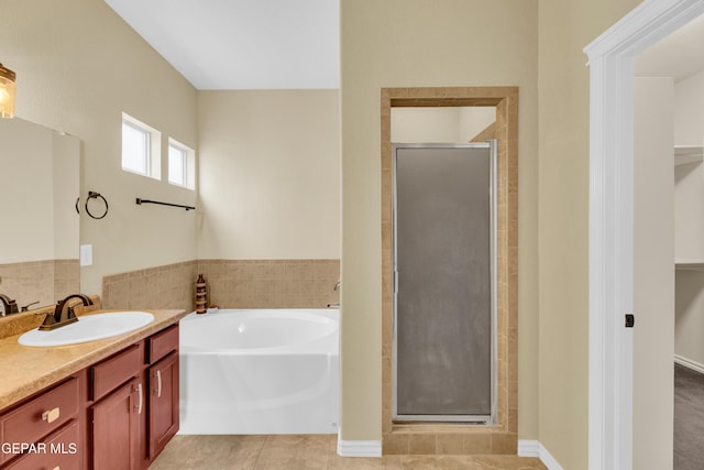 2937 Pino Triste Dr, El Paso, TX 79938 - bathroom with a stall shower, vanity, a bath, a spacious closet, and tile patterned flooring