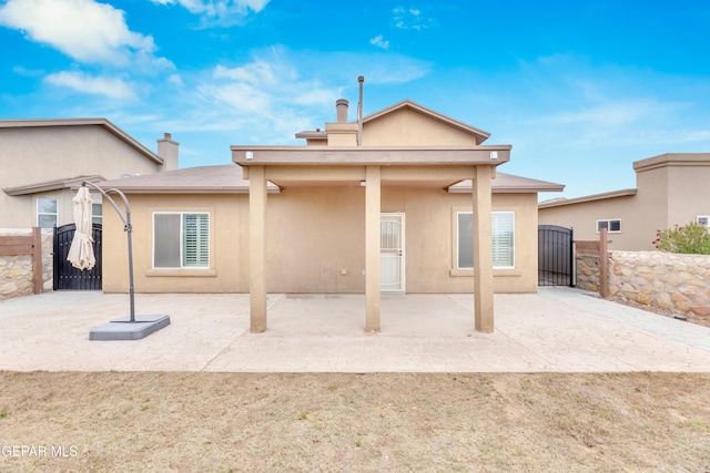 2937 Pino Triste Dr, El Paso, TX 79938 - rear view of house featuring a gate, stucco siding, and a patio