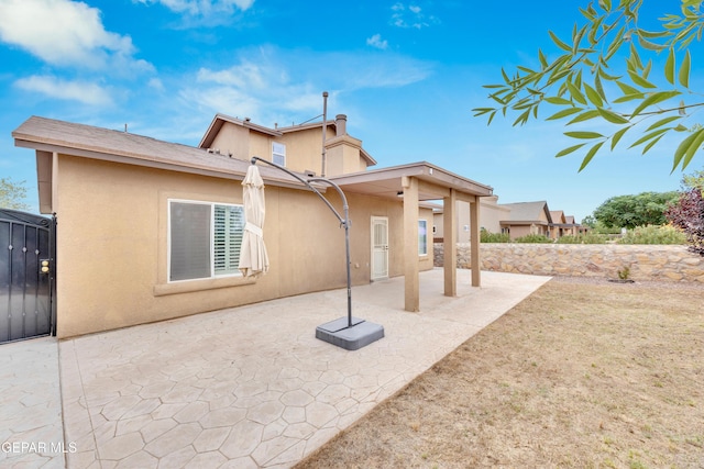 2937 Pino Triste Dr, El Paso, TX 79938 - back of house with stucco siding and a patio