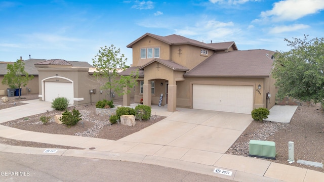 2937 Pino Triste Dr, El Paso, TX 79938 - view of front facade with stucco siding, driveway, and a garage