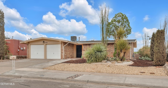 7308 Cerro Negro Dr, El Paso, TX 79912 - view of front of home with an attached garage, brick siding, and concrete driveway