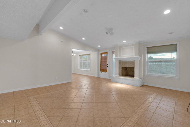7308 Cerro Negro Dr, El Paso, TX 79912 - unfurnished living room featuring light tile patterned floors, plenty of natural light, recessed lighting, and a fireplace with raised hearth