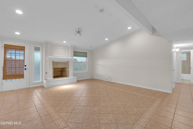 7308 Cerro Negro Dr, El Paso, TX 79912 - unfurnished living room with light tile patterned floors, inlaid floor details, recessed lighting, a tile fireplace, and ornamental molding